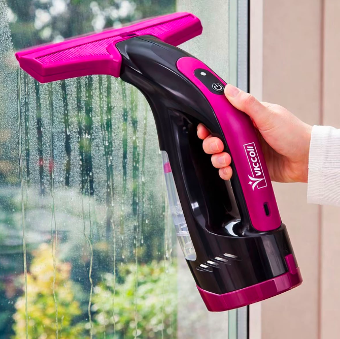 Limpador de vidro elétrico sem fio rosa e preto em uso